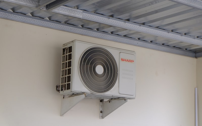 Person adjusting a modern digital thermostat in their home