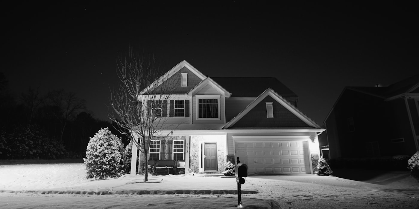 Residential home with warm exterior lighting at night